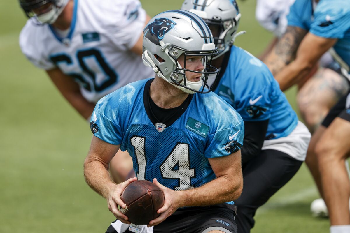 Carolina Panthers quarterback Sam Darnold (14) prepares to hand off the football during NFL football practice in Charlotte, N.C., Wednesday, June 8, 2022. (AP Photo/Nell Redmond)