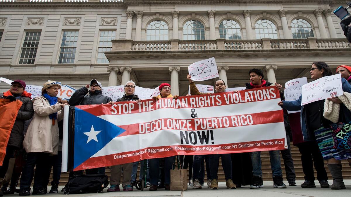 Activists rally in support of Puerto Rican families displaced by Hurricane Maria April 19 in New York City.