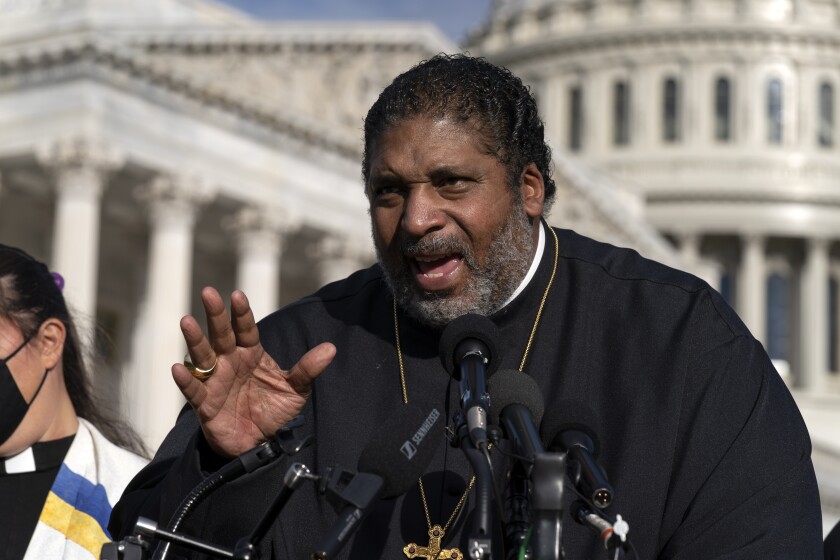 FILE - The Rev. William Barber and the Poor People's Campaign talk to reporters about the need for the "Build Back Better" plan, voting rights, health care, immigrant rights and action on climate change, during a news conference on Capitol Hill in Washington, Wednesday, Oct. 27, 2021. On Friday, May 6, 2022, North Carolina's highest court announced that it is refusing to hear the appeal of Barber, a civil rights leader who was convicted of trespassing during a 2017 demonstration inside the Legislative Building. (AP Photo/Jose Luis Magana, File)