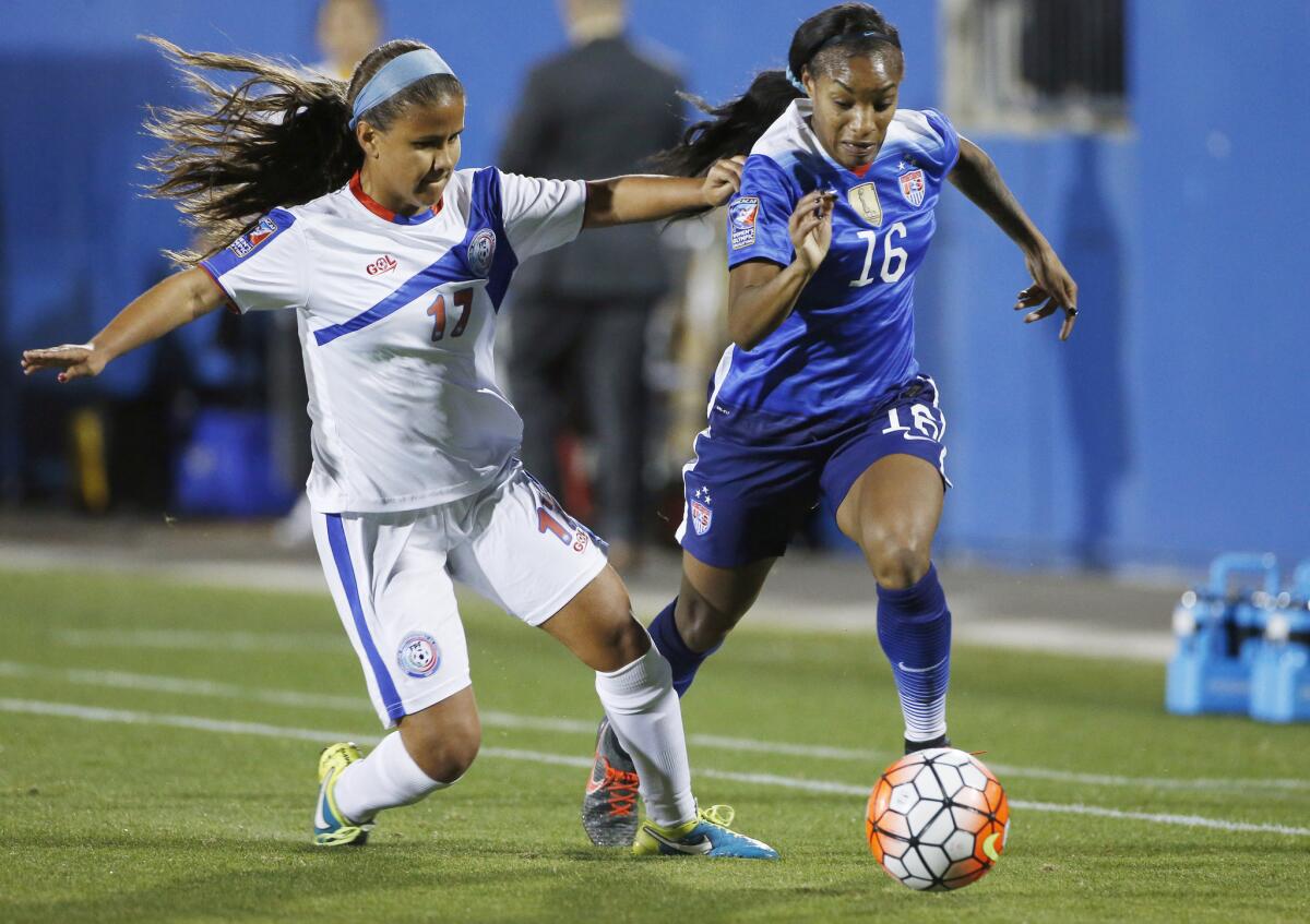 United States forward Crystal Dunn (16) battles with Puerto Rico defender Adriana Isabel Font (17) for the ball during the first half.