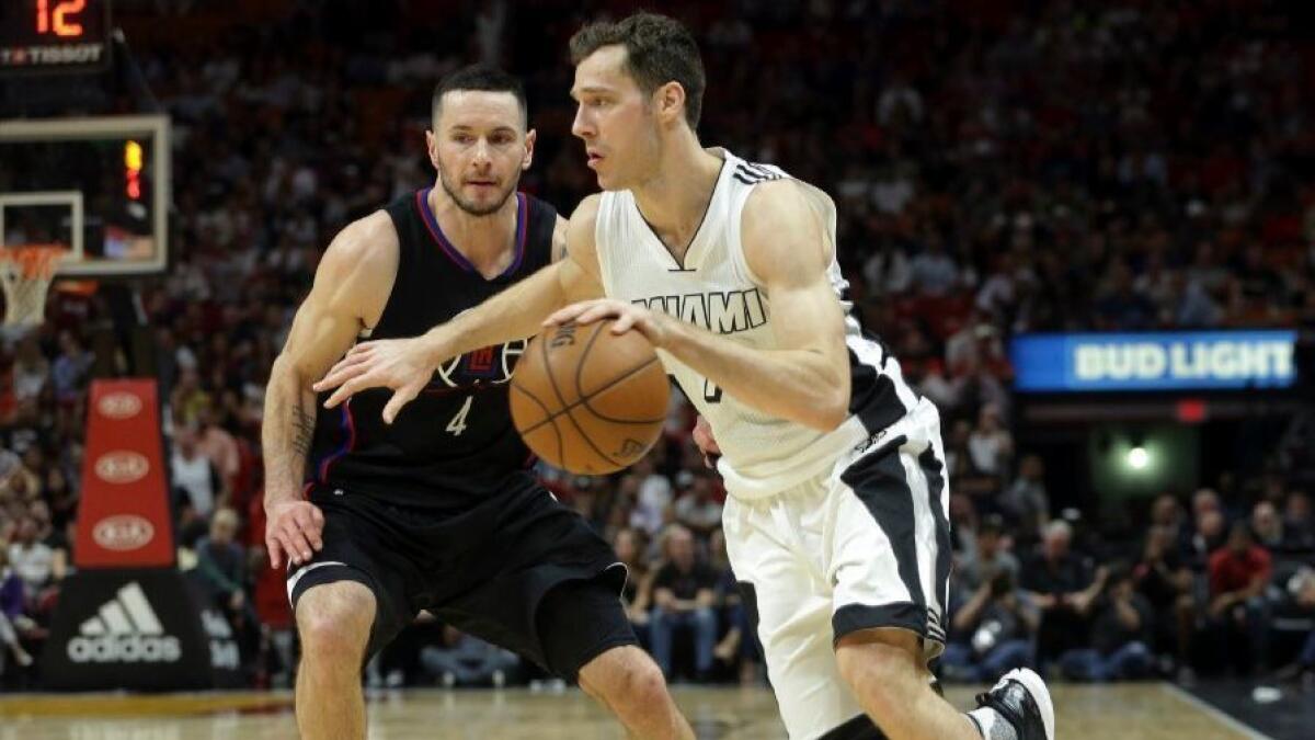 Heat guard Goran Dragic drives to the basket past Clippers guard J.J. Redick during the second half in Miami on Dec. 16.