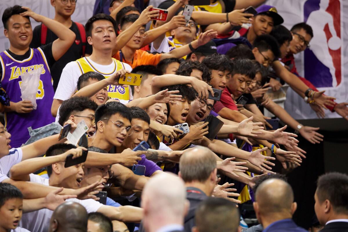 Fans reach out to players after an NBA preseason game between the Lakers and Brooklyn Nets in China on Oct. 12.