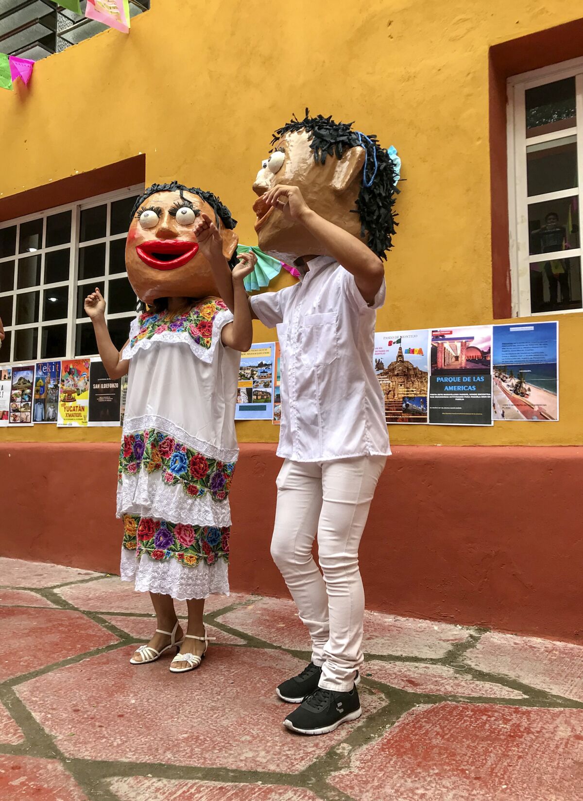 Two traditional "dancing dolls" at a festival in a Merida cultural center.