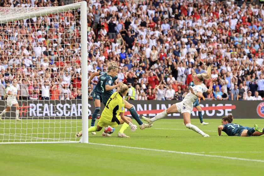 England's Chloe Kelly scores her side's second goal during the Women's Euro 2022 final soccer match between England and Germany at Wembley stadium in London, Sunday, July 31, 2022. (AP Photo/Leila Coker)