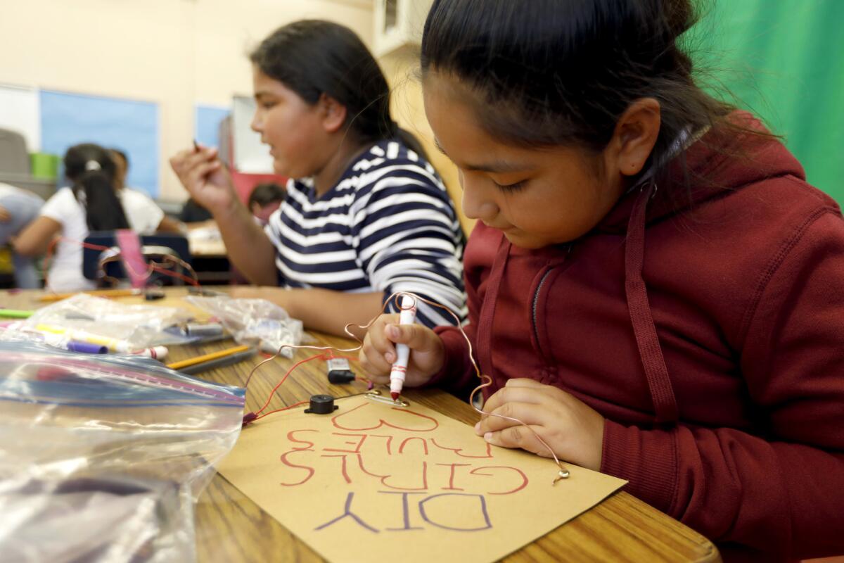 Judith Ayala, 10, and other classmates prepare for an experiment in the Do It Yourself Girls program at Telfair Elementary School in Pacoima.