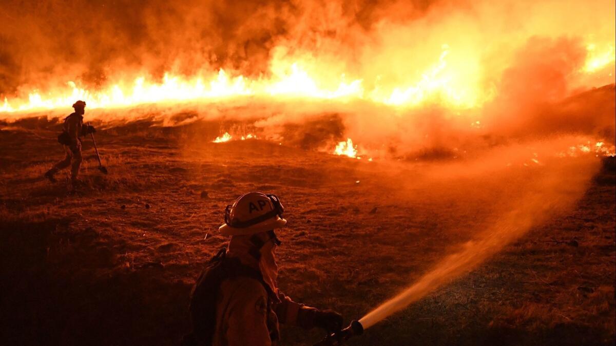 The Ranch fire was started by a homeowner using a hammer and stake, Cal Fire announced Thursday. Above, firefighters monitor a controlled burn as part of their containment efforts to cut off the Ranch fire's path in 2018.
