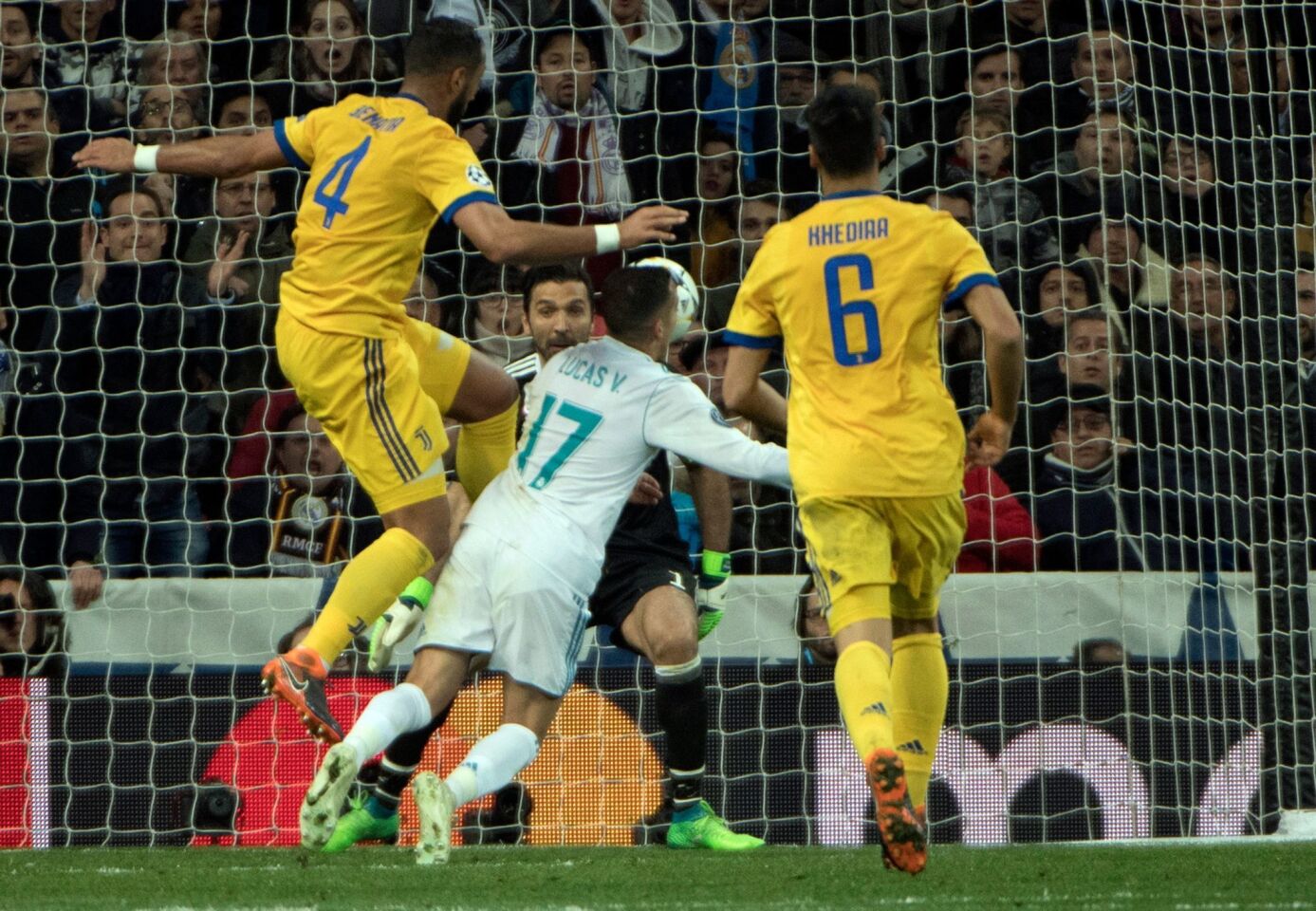 Real Madrid's Spanish midfielder Lucas Vazquez (2R) vies with Juventus' Italian defender Medhi Benatia (L) in front of Juventus' Italian goalkeeper Gianluigi Buffon during the UEFA Champions League quarter-final second leg football match between Real Madrid CF and Juventus FC at the Santiago Bernabeu stadium in Madrid on April 11, 2018. / AFP PHOTO / CURTO DE LA TORRECURTO DE LA TORRE/AFP/Getty Images ** OUTS - ELSENT, FPG, CM - OUTS * NM, PH, VA if sourced by CT, LA or MoD **