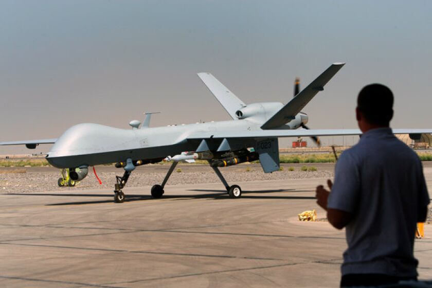 An unmanned Reaper aircraft is steered around the Kandahar air base in southern Afghanistan last year.