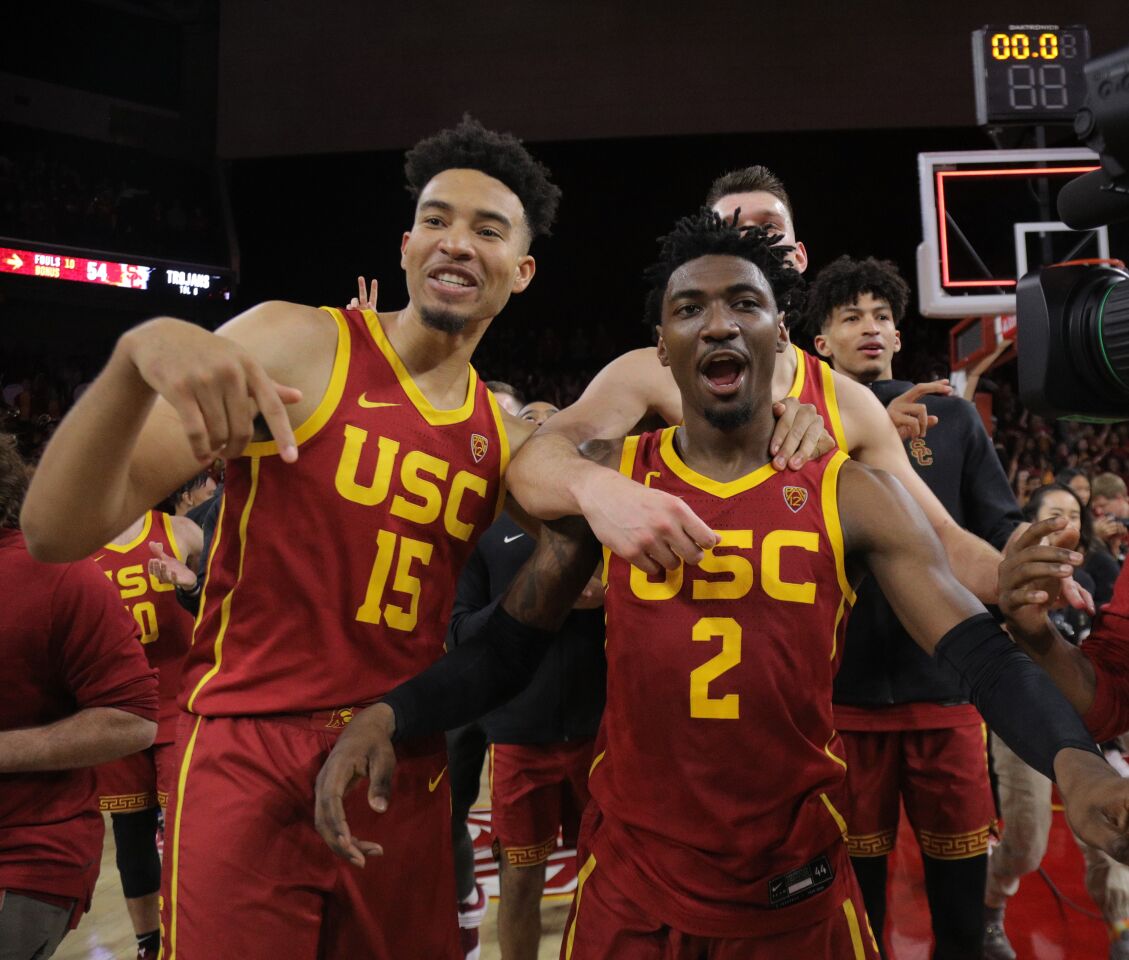 USC guard Jonah Mathews (2) celebrates with forward Isaiah Mobley (15) and forward Nick Rakocevic after scoring the winning basket in the Trojans' 54-52 triumph over UCLA at Galen Center on March 7, 2020.