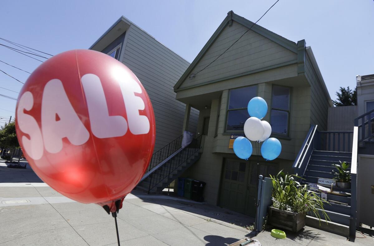 A sale balloon for a nearby store is shown next to a property in the Bay Area's Noe Valley neighborhood that sold for $1.8 million, $600,000 more than its asking price, on July 30.