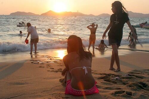 Locals fill the beaches on a Friday at sunset on Icacos beach in Acapulco.