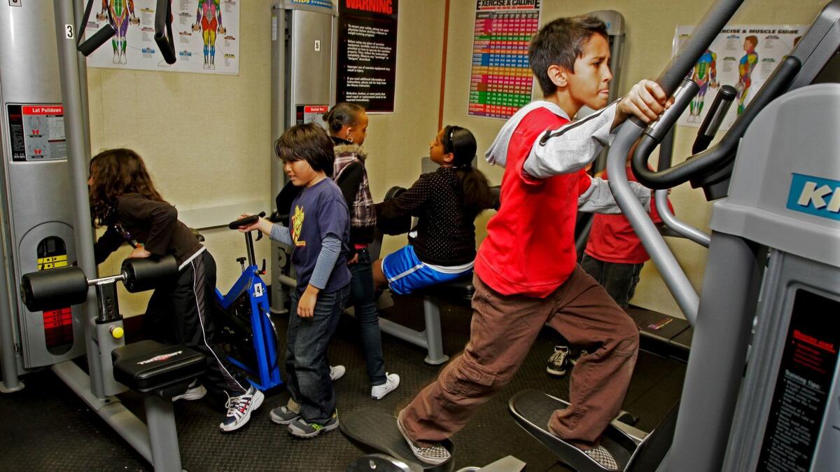 Luke Hakanen, 9, works out as fourth and fifth grade students exercise at the fitness center at Kentwood Elementary School in Los Angeles.