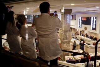 Doctors from the Alabama Fertility Clinic takes photos of the votes as the debate over SB159 bill (IVF Fertility Bill) in the House Chambers is voted on, Wednesday, March 6, 2024, in Montgomery, Ala. (AP Photo/ Butch Dill)