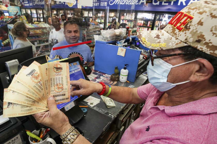 Ronald Marine, right, sells $200 worth of Mega Millions lottery to Paul Sandoval