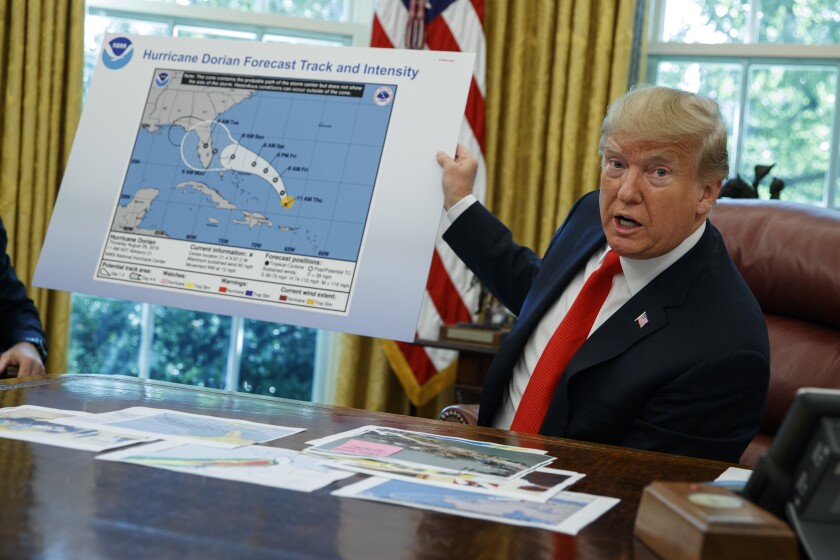 FILE - In this Wednesday, Sept. 4, 2019, file photo, President Donald Trump talks with reporters after receiving a briefing on Hurricane Dorian in the Oval Office of the White House, in Washington. A new 46-person federal scientific integrity task force with members from dozens of government agencies will meet for the first time Friday, May 14, 2021. During Sharpiegate, NOAA reprimanded some meteorologists for tweeting that Alabama was not threatened by the hurricane, contradicting the president, who said Alabama was in danger. (AP Photo/Evan Vucci, File)