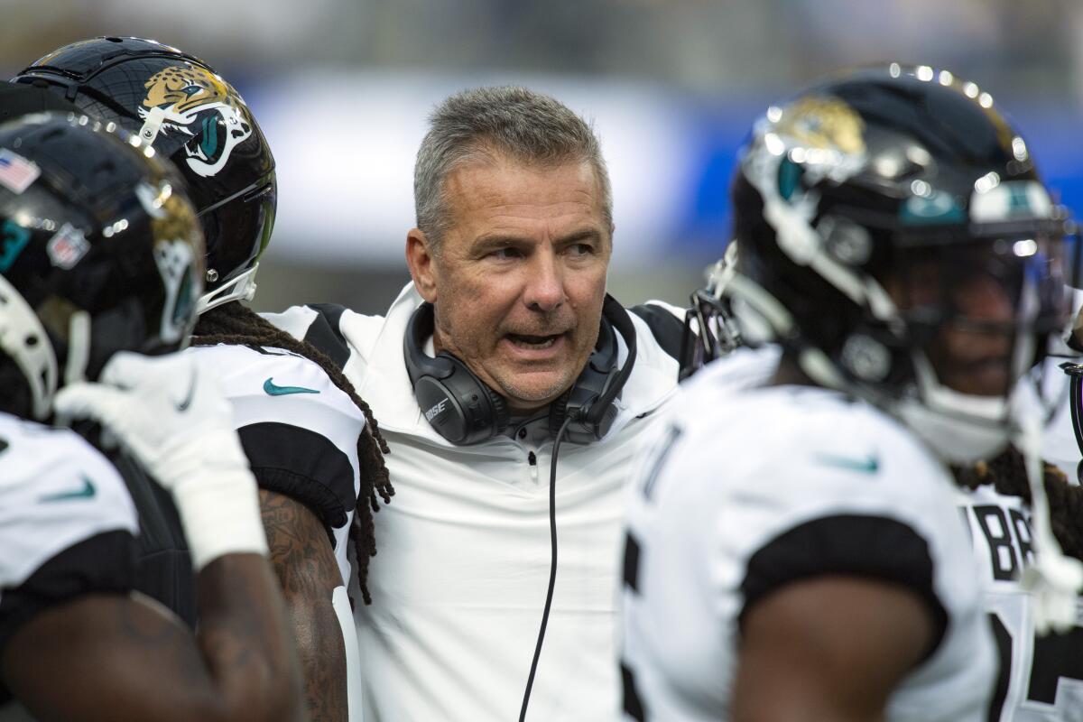 Urban Meyer talks to players during a game.