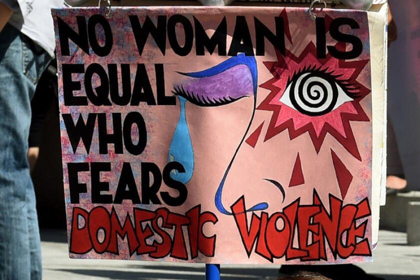Women protest against domestic violence during an International Women's Day march in downtown Los Angeles on March 8, 2015.