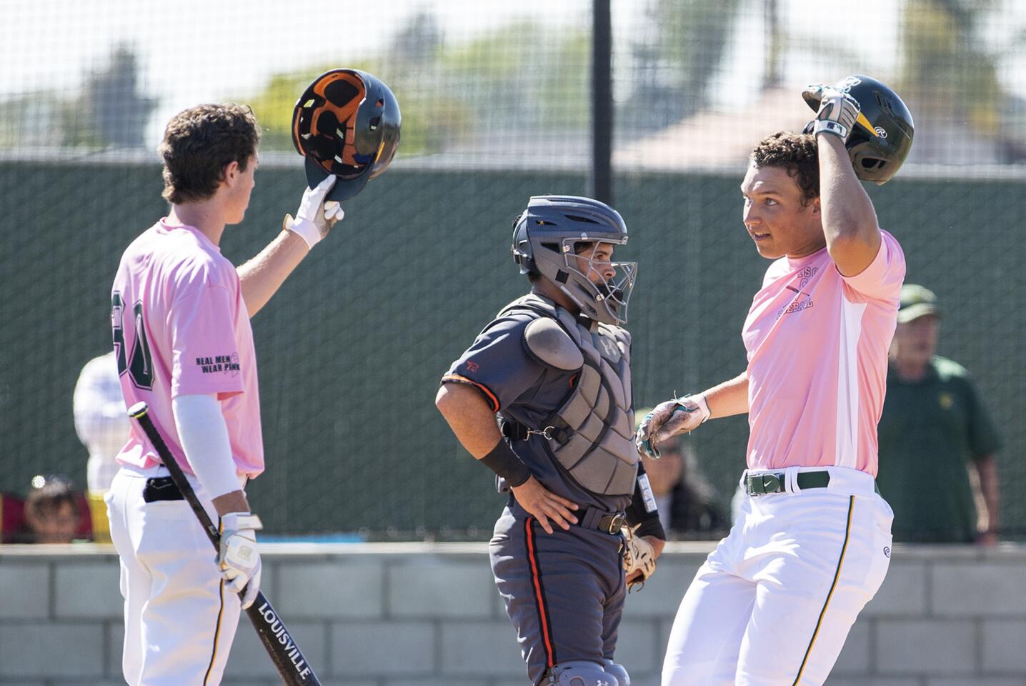 Edison's Matt Swartz, right, gets a high five from Spencer Serven after hitting a solo home run against Huntington Beach during a Sunset League game on Tuesday, May 8.