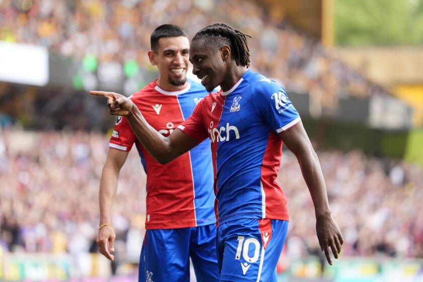 Crystal Palace's Eberechi Eze celebrates scoring his sides third goal with Daniel Munoz, left, during the English Premier League soccer match between Wolverhampton Wanderers and Crystal Palace, at Molineux, Wolverhampton, England, Saturday May 11, 2024. (Nick Potts/PA via AP)