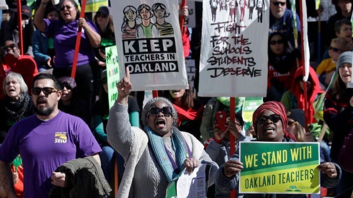 Teachers, students and supporters rally last week at Frank Ogawa Plaza in front of Oakland City Hall. School leaders and teachers reached a tentative deal Friday, ending a weeklong strike.