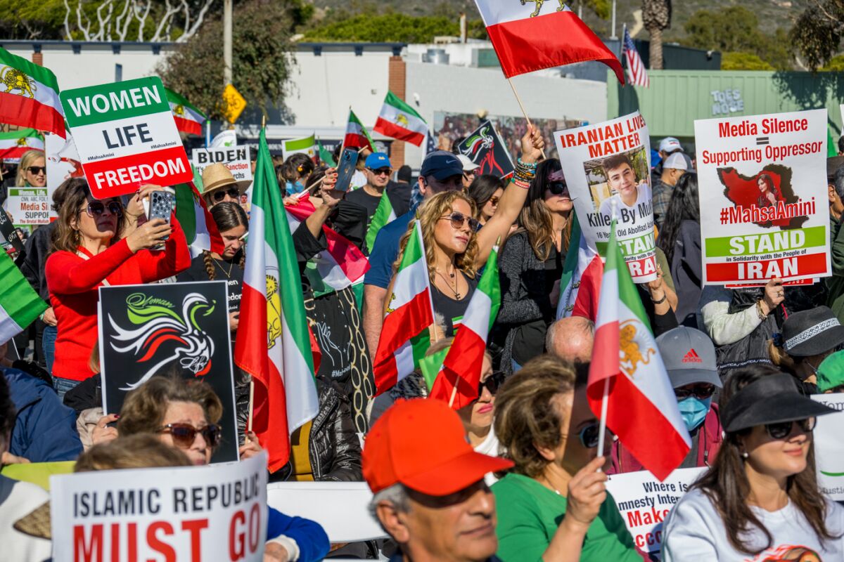 Supporters of the Iranian people in their fight for freedom demonstrate at Main Beach in Laguna Beach on Dec. 10.