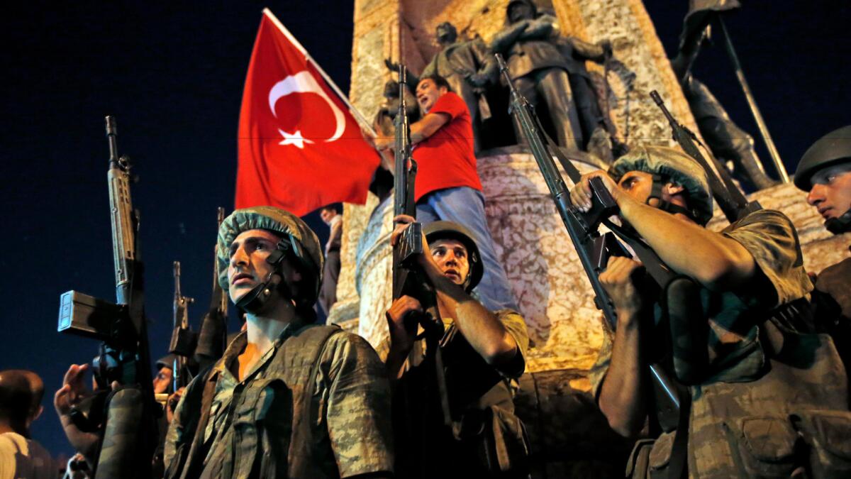 Turkish soldiers secure the area as supporters of President Recep Tayyip Erdogan protest in Istanbul's Taksim square on July 16, 2016.