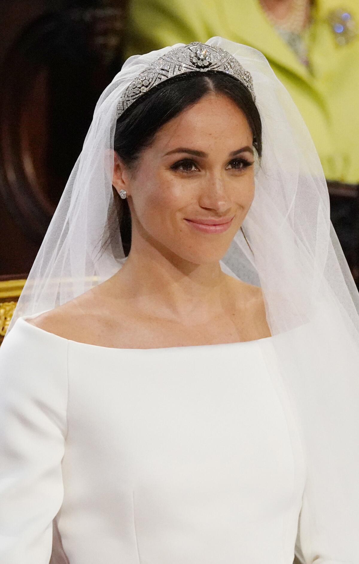 Meghan Markle wore a diamond tiara for her wedding to Prince Harry on Saturday. Here, the bride, a former "Suits" actress, stands at the altar during the ceremony in St. George's Chapel at Windsor Castle.
