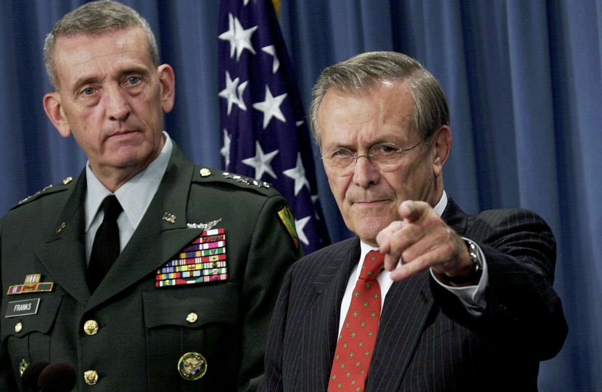 Secretary of Defense Donald Rumsfeld calls on a Pentagon reporter during a briefing on the ongoing military operations in Afghanistan as General Tommy Franks, the field commander for the operations, listens on Nov. 15, 2001.