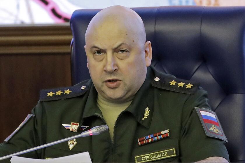 FILE - Colonel General Sergei Surovikin, Commander of the Russian forces in Syria, speaks, with a map of Syria projected on the screen in the back, at a briefing in the Russian Defense Ministry in Moscow, Russia, June 9, 2017. Surovikin has become the face of Russia’s new strategy in Ukraine, which includes unleashing a barrage of strikes against the country's infrastructure. (AP Photo/Pavel Golovkin, File)