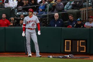 OAKLAND, CALIFORNIA - MARCH 30: Shohei Ohtani #17 of the Los Angeles Angels stands by the new pitch clock.