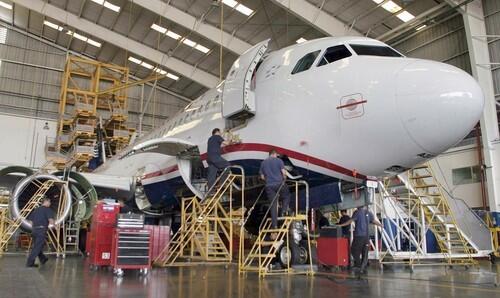 A jetliner undergoes maintenance at Aeroman's facility in El Salvador. U.S. airlines outsource more than half of their aircraft to domestic and foreign maintenance firms.