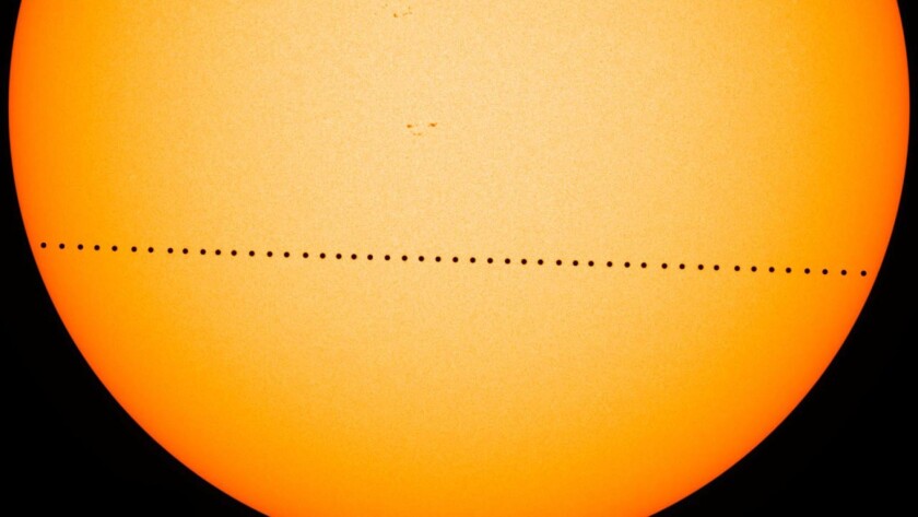 In this composite image, the planet Mercury passes directly between the sun and Earth on May 9, 2016. Another transit will happen Nov. 11.