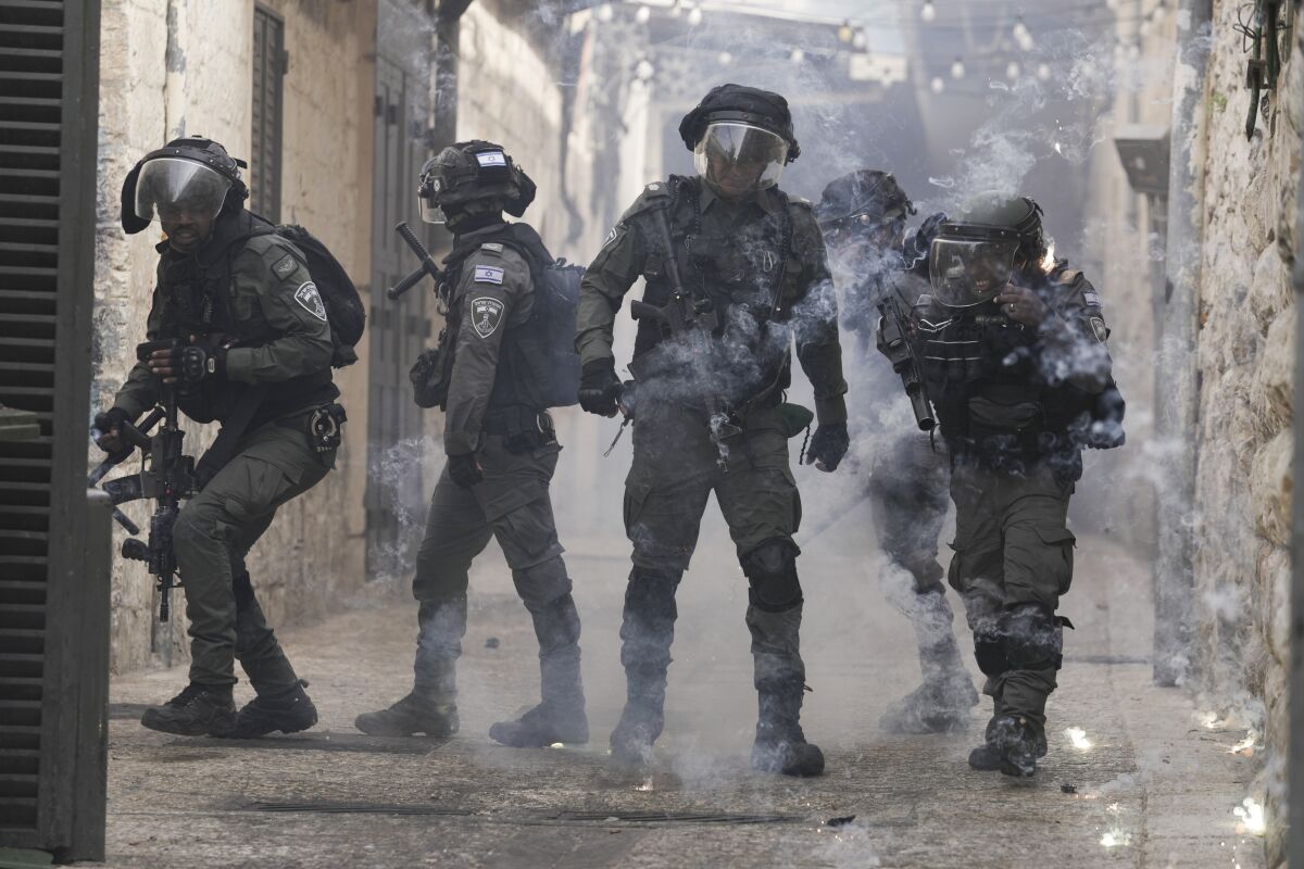 Palestinians shoot fireworks at Israeli police in the Old City of Jerusalem.