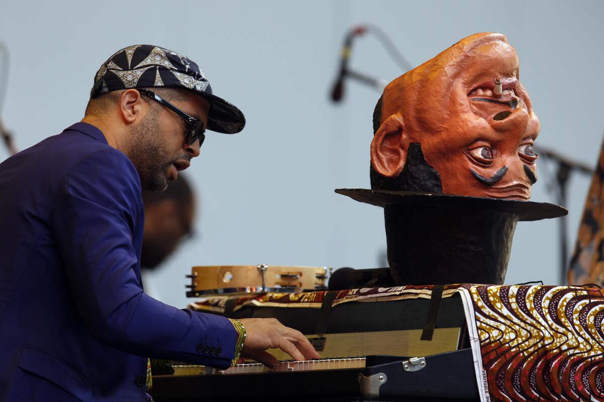 Jason Moran — with custom-sculpted Fats Waller mask — onstage on Saturday.