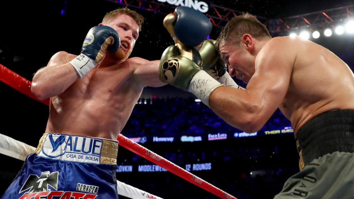 Gennady Golovkin, right, tries to evade a punch by Canelo Alvarez during their middleweight championionship bout. To see more images from the fight, click on the photo.