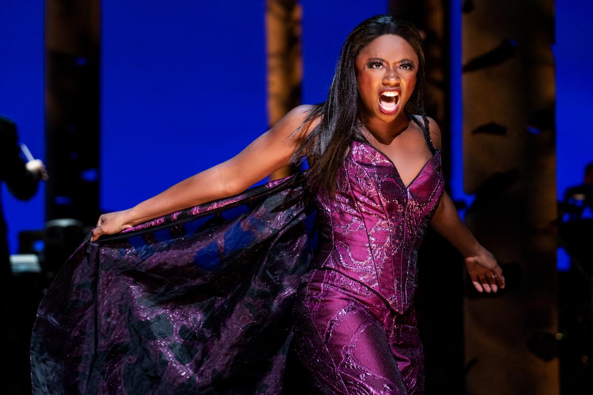 Montego Glover holds the train of her purple gown in "Into the Woods"