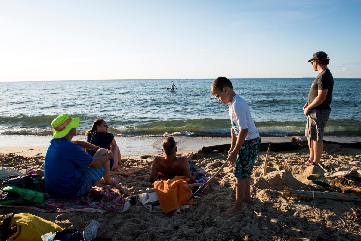 Beachgoers relax at Sleeping Bear Dunes National Lakeshore in Michigan, where new beach wheelchairs will be available.