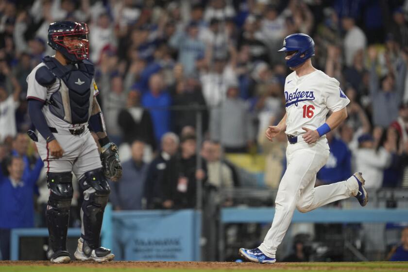 Los Angeles Dodgers' Will Smith (16) scores on a walk-off single hit by Andy Pages during the eleventh inning of a baseball game against the Atlanta Braves in Los Angeles, Friday, May 3, 2024. The Dodgers won 4-3. (AP Photo/Ashley Landis)