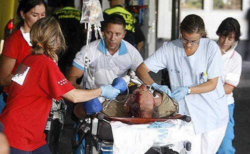 A medical team tends an injured passenger in Madrid's Barajas airport after a Spanair jetliner bound for the Canary Islands swerved off the runway and caught fire.