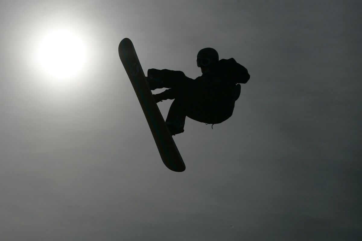 FILE - A silhouette of a snowboarder in action in a heat during the FIS World Cup snowboarding big air competition at the Battersea Power Station in London, Saturday, Oct. 25, 2008. When former members of the U.S. snowboarding team sought to report sex-abuse allegations against a longtime coach, they received conflicting information that left them unsure of where to turn — or whether they wanted to pursue the cases at all. (AP Photo/Sang Tan, File)