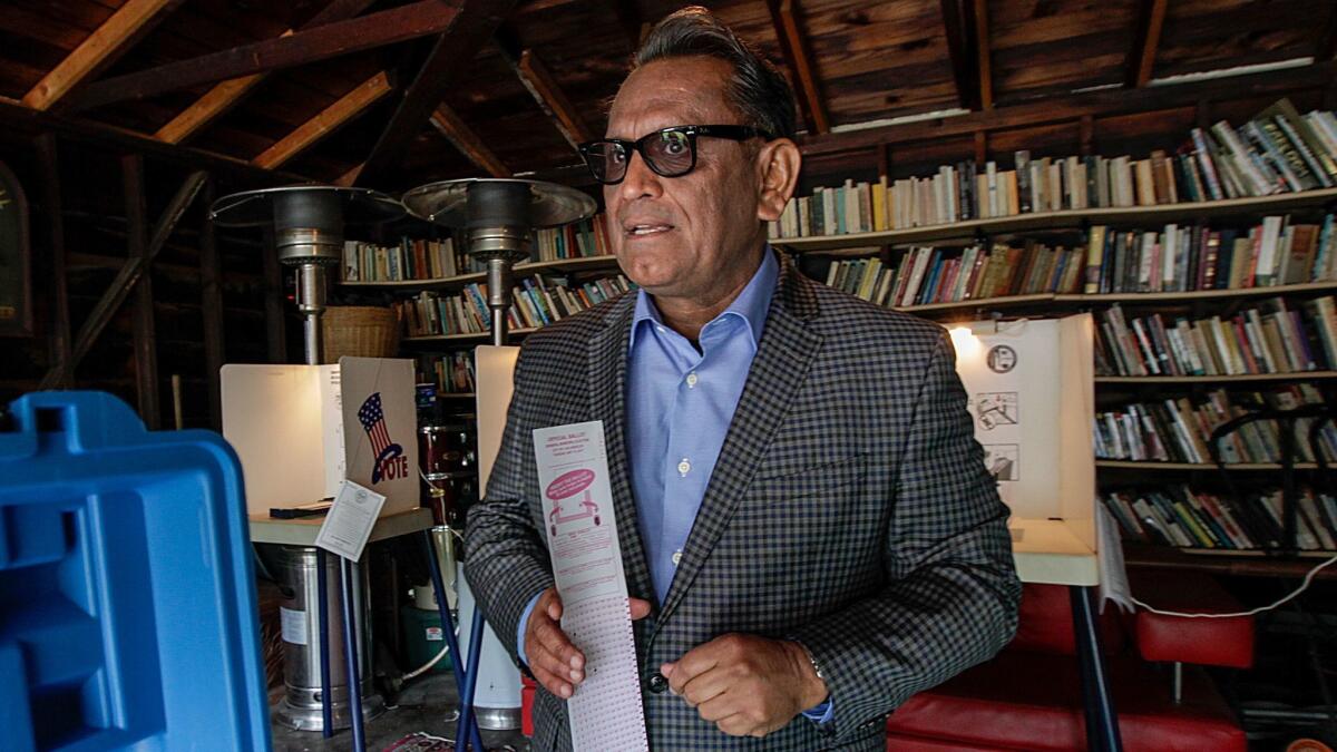 City Councilman Gil Cedillo casts his vote at a polling station in a residence on Edgeware Road in Los Angeles on May 16.