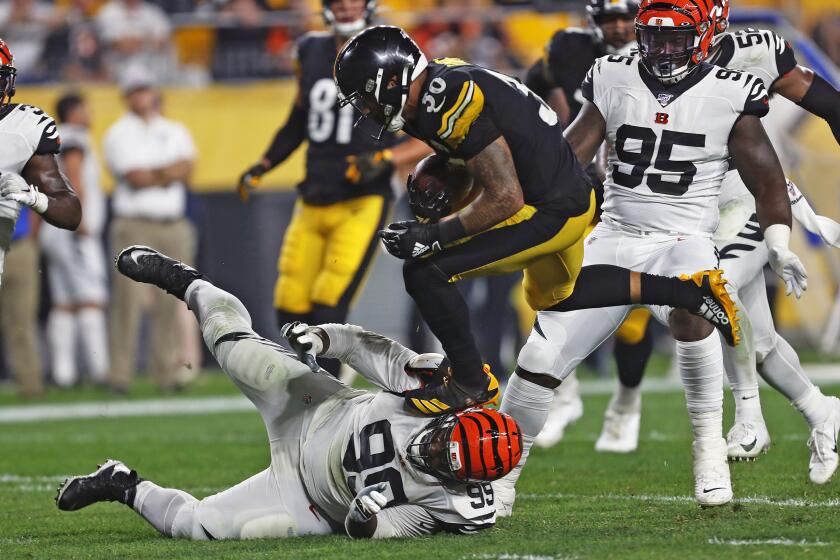 Pittsburgh Steelers running back James Conner (30) runs over Cincinnati Bengals defensive tackle Andrew Billings (99) during the second half of an NFL football game in Pittsburgh, Monday, Sept. 30, 2019. (AP Photo/Tom Puskar)