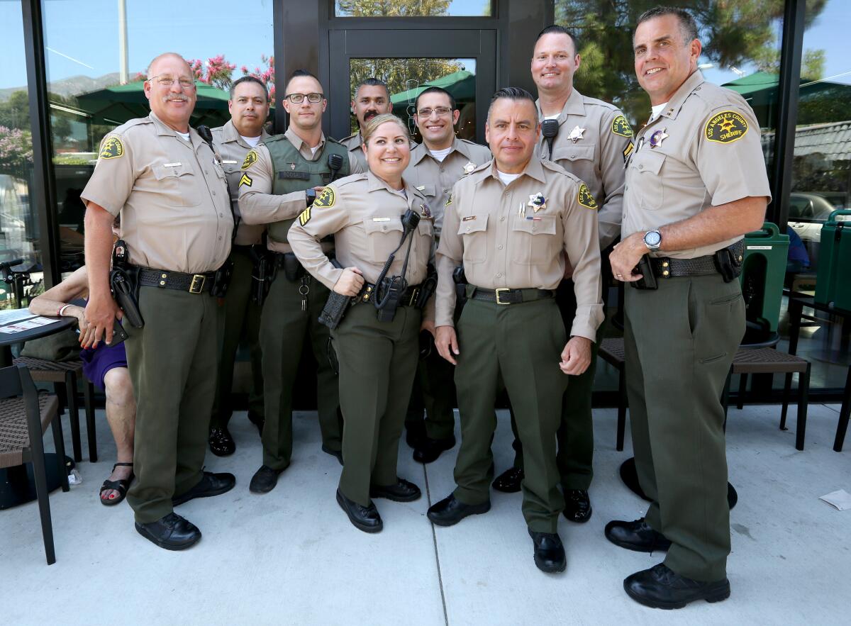 Crescenta Valley Sheriff Station Capt. Todd Deeds, right, with some of the station’s staff at "Coffee with the Captain" event.