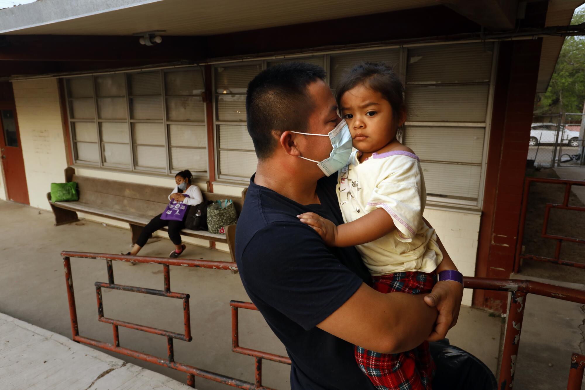 Luis Enrique Rodriguez Villeda holds his daughter.