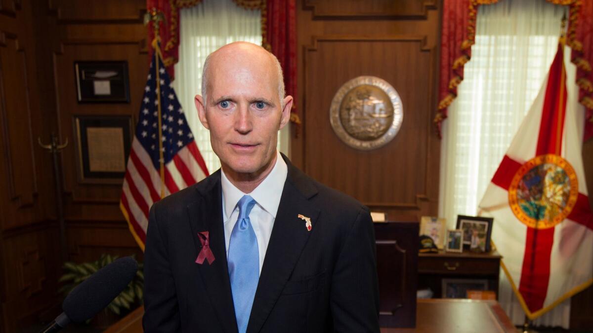 Florida Gov. Rick Scott talks to the media on March 9.