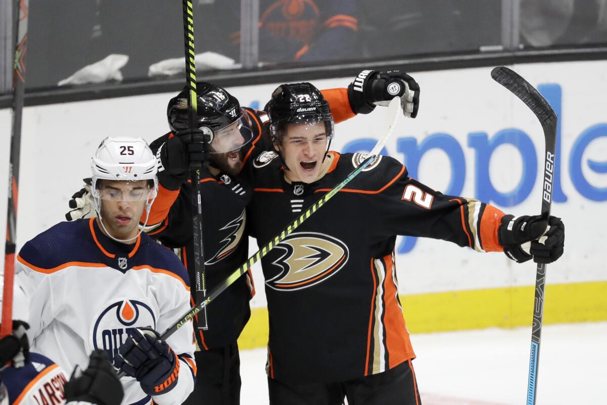 Ducks left wing Sonny Milano, right, celebrates after scoring the winning goal with center Adam Henrique during overtime against the Edmonton Oilers on Tuesday at the Honda Center.