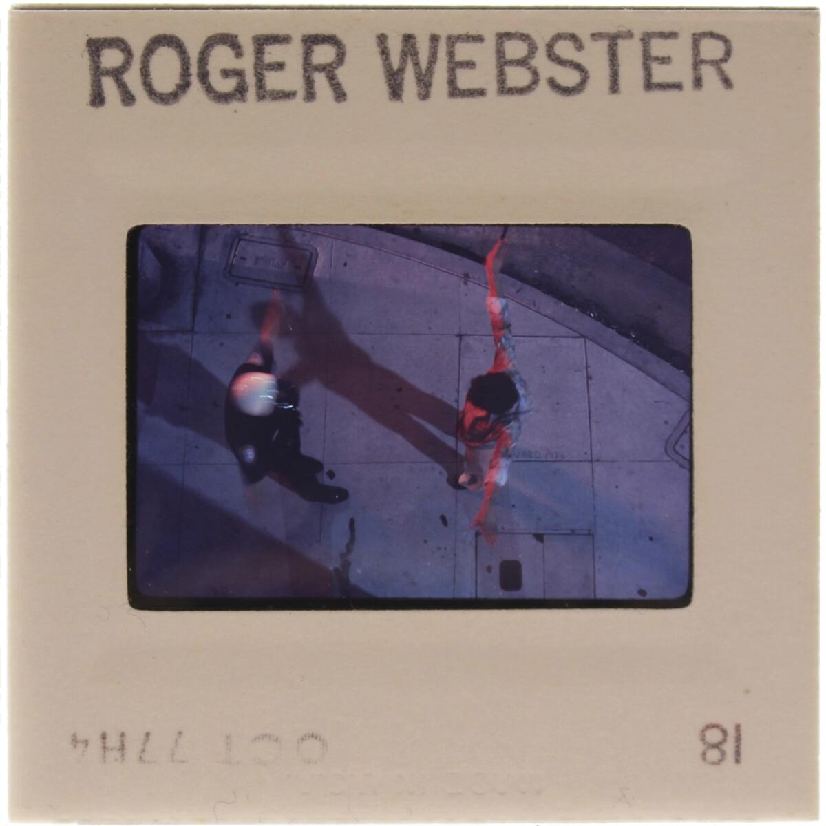 A photograph by Roger Webster of a sidewalk encounter with the Los Angeles police. (Environmental Communications and LAXART)