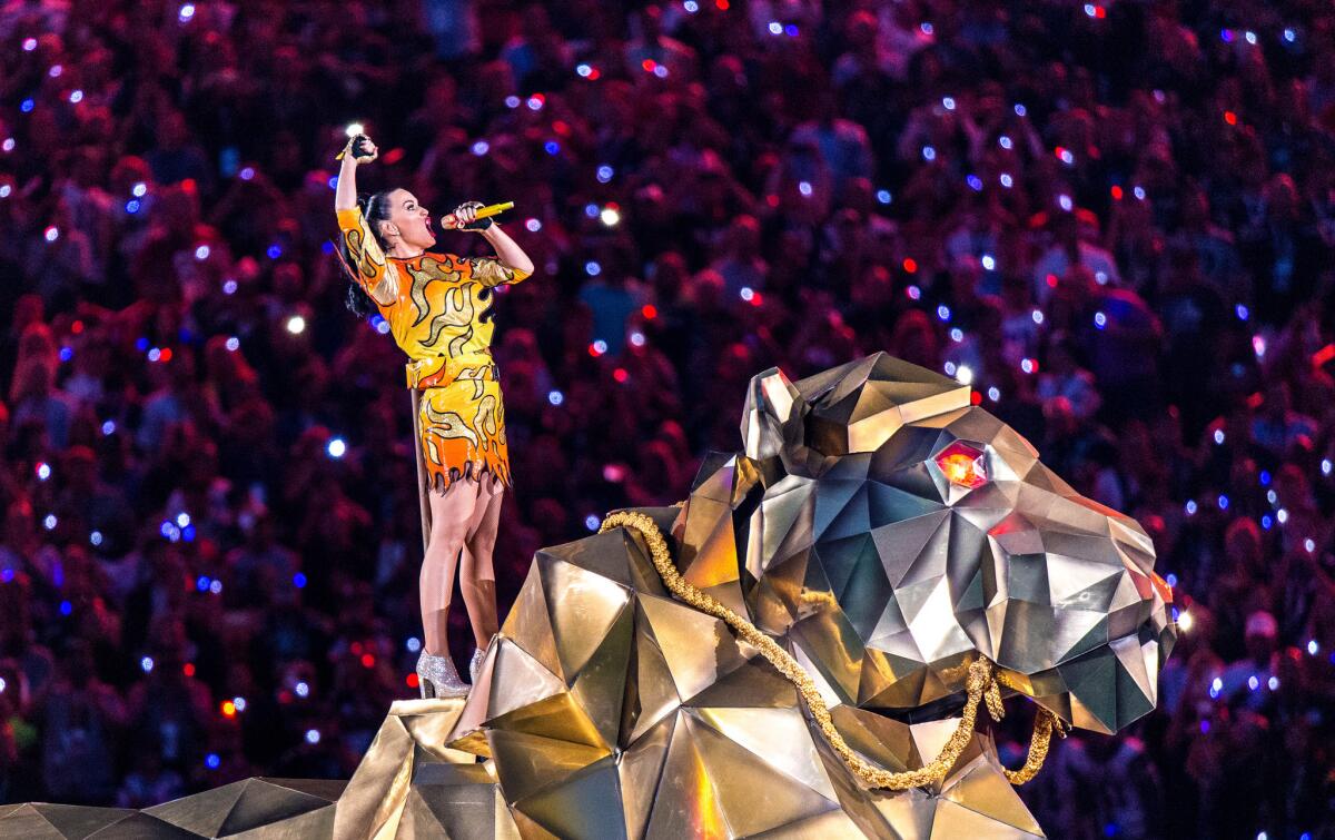 Katy Perry wears a flame-emblazoned minidress by Jeremy Scott during the Super Bowl XLIX halftime show.