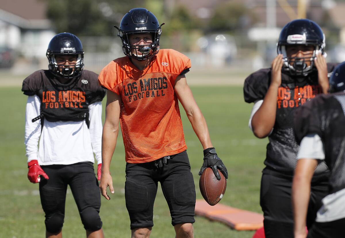 Los Amigos quarterback Justin Boyer, center, shown during practice on Aug. 9, has four touchdown passes and 25 tackles this year.