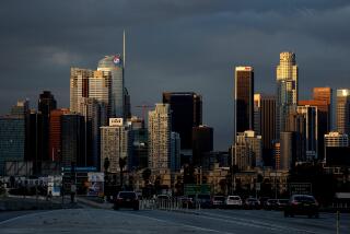 LOS ANGELES, CA - FEBRUARY 26: Clouds hover in the background of downtown Los Angeles skyline after a powerful winter storm passed though over the weekend causing flooding and power outages in some areas on Sunday, Feb. 26, 2023 in Los Angeles, CA. A powerful winter storm system that forecasters say will bring an extended period of cold temperatures, high winds and snow, prompting the region's first blizzard warning on record. (Gary Coronado / Los Angeles Times)